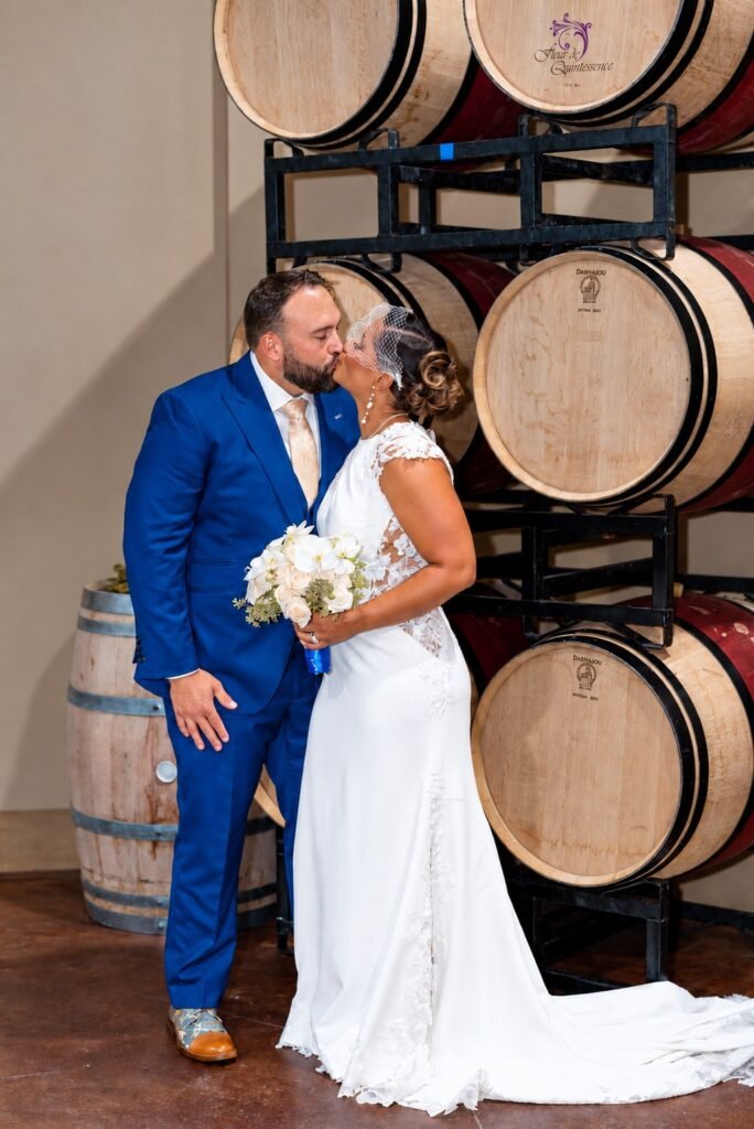 Couple portrait beside wine barrels at Montaluce Winery in Dahlonega, Georgia.