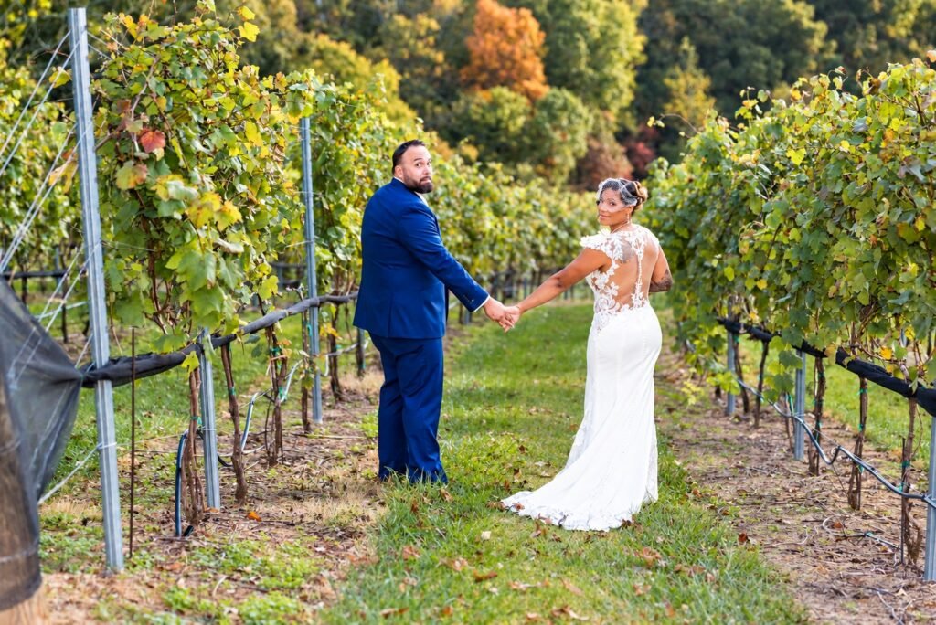 Couple walking among vineyard rows at Montaluce Winery in Dahlonega, Georgia.