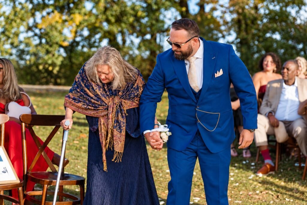 Groom accompanying a guest outdoors at Montaluce Winery in Dahlonega, Georgia.